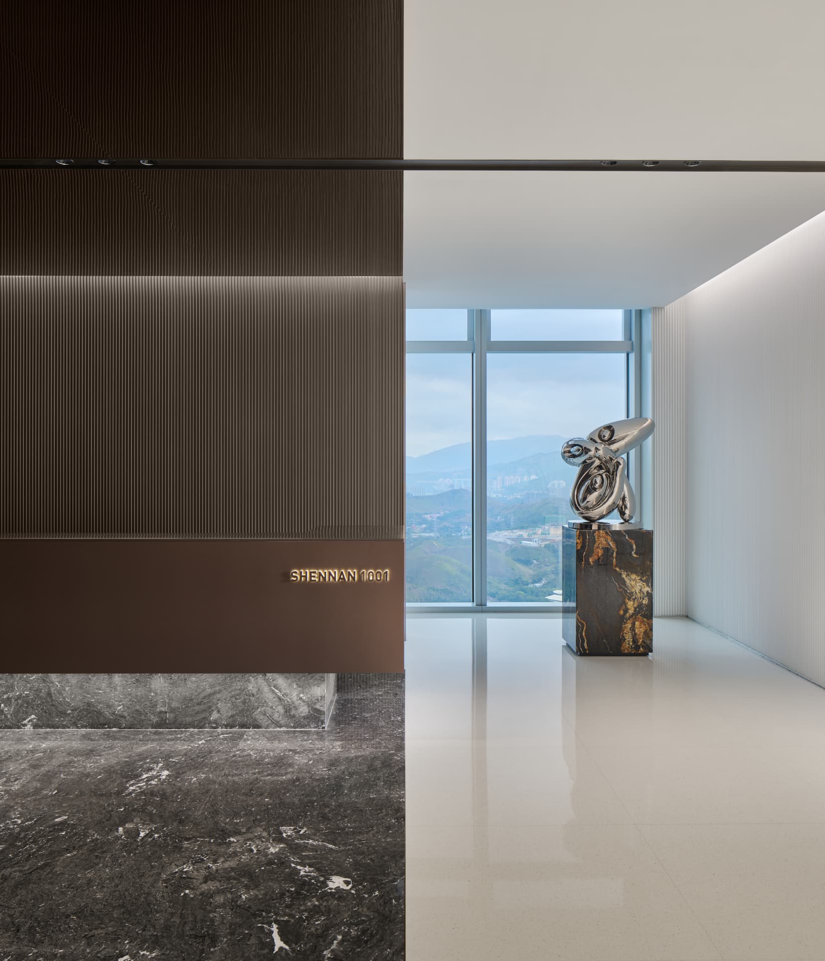 No.1 Shennan Road — China: No.1 Shennan Road, Shenzhen — lobby detail with backlit signage and sculpture