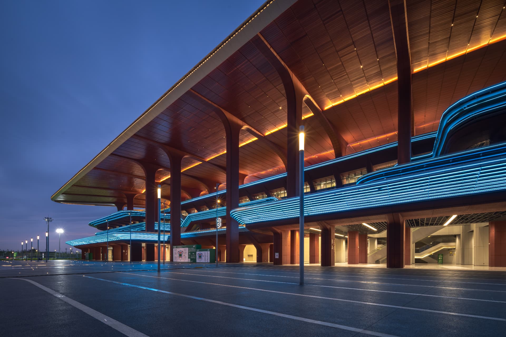 Xi'an International Football Stadium — Xi'an, China: Xi'an International Football Stadium, Xi'an — concourse canopy with warm soffit lighting and blue light lines