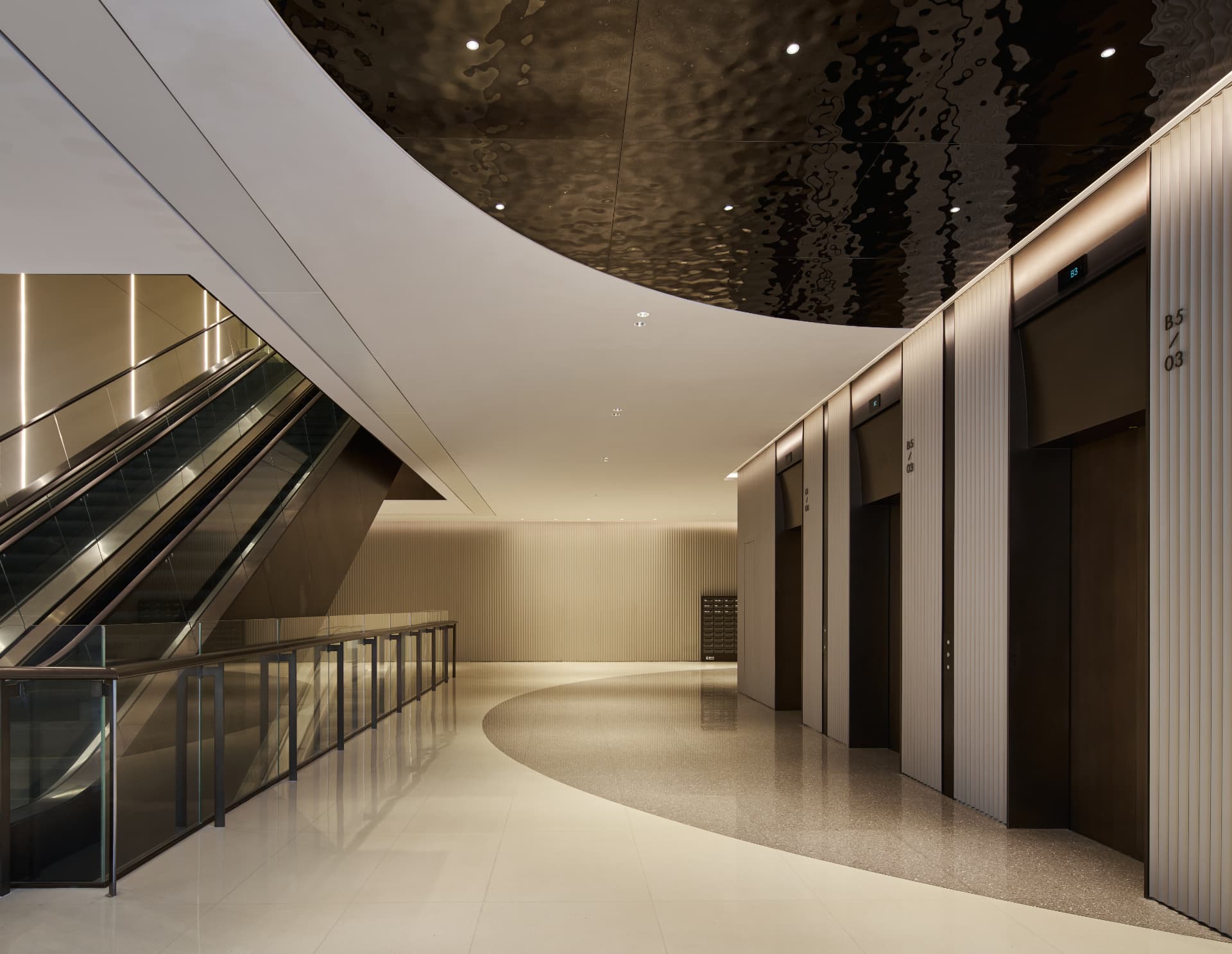 No.1 Shennan Road — China: No.1 Shennan Road, Shenzhen — escalator hall with curved ceiling and lift lobby