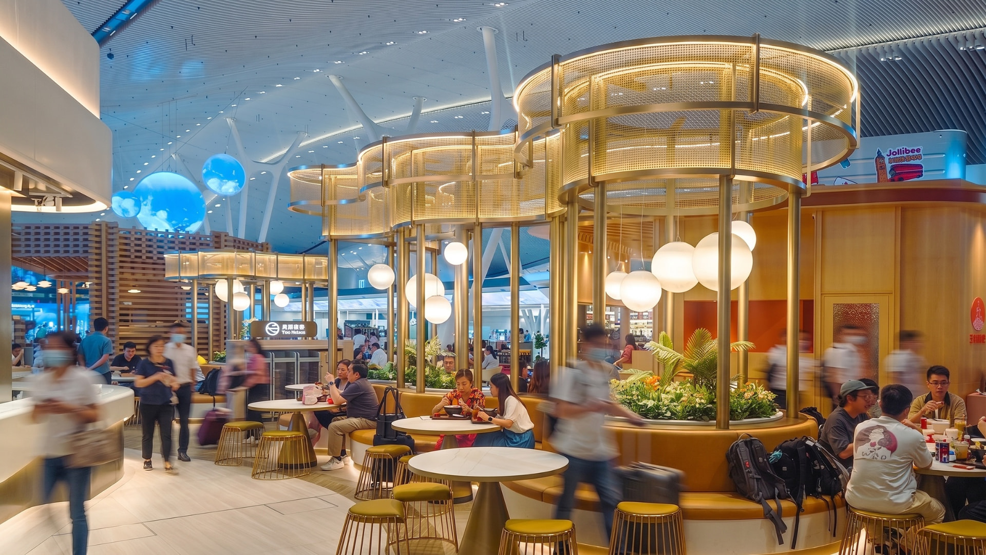 Hong Kong International Airport – Terminal 2 — Hong Kong: Hong Kong International Airport Terminal 2 — dining area with warm decorative lighting, Lichtvision lighting design