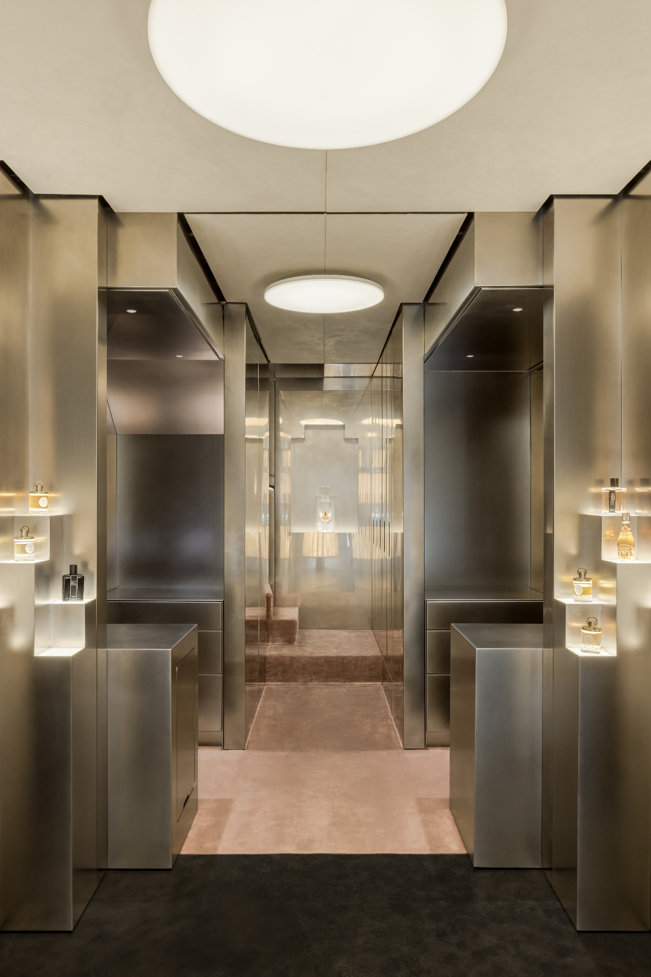 Parfums Caron, Rue Saint Honoré — Paris, France: Mirrored corridor with soft ceiling luminaires leading to a private area