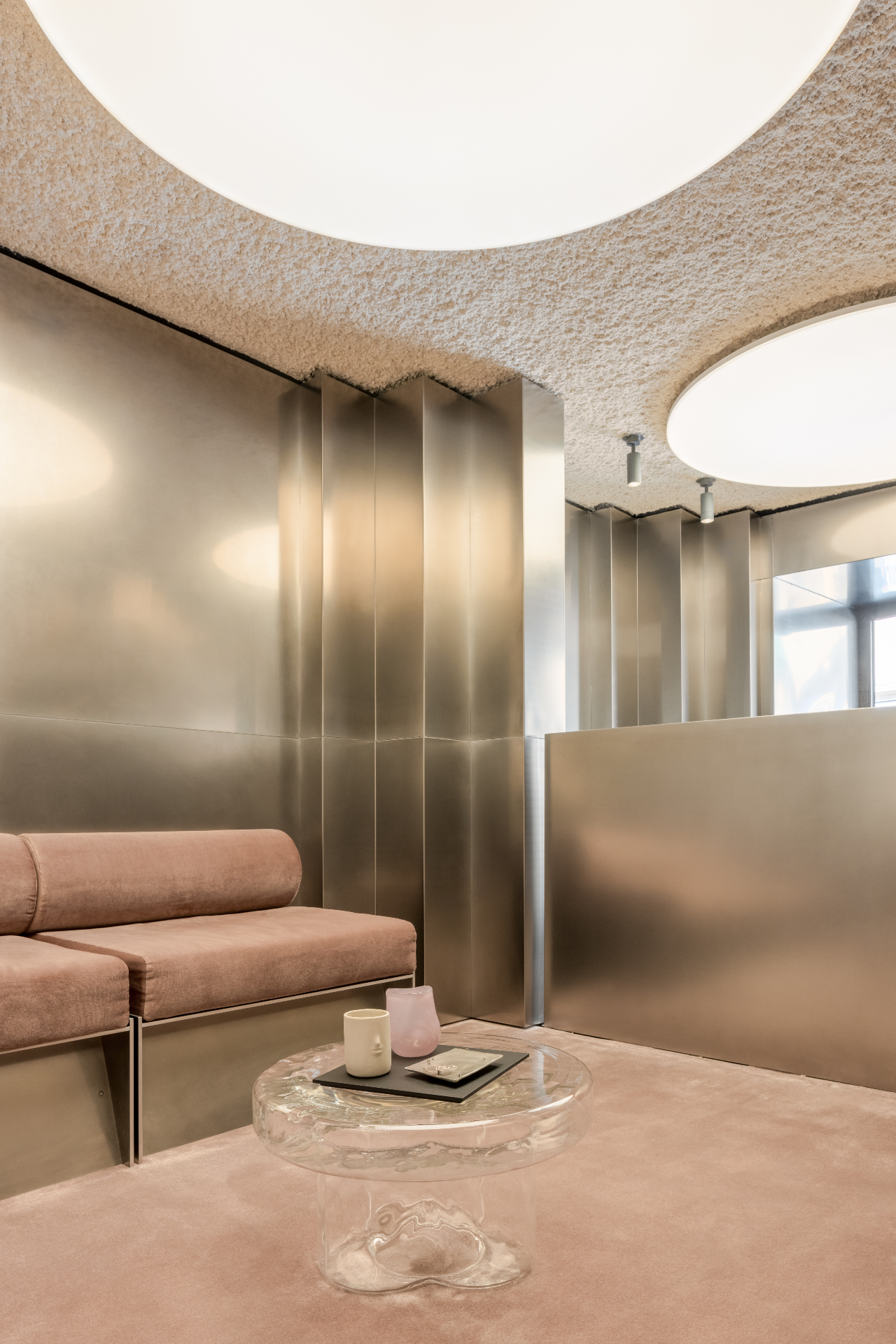 Parfums Caron, Rue Saint Honoré — Paris, France: Intimate lounge with blush carpet, metallic walls and diffused overhead lighting