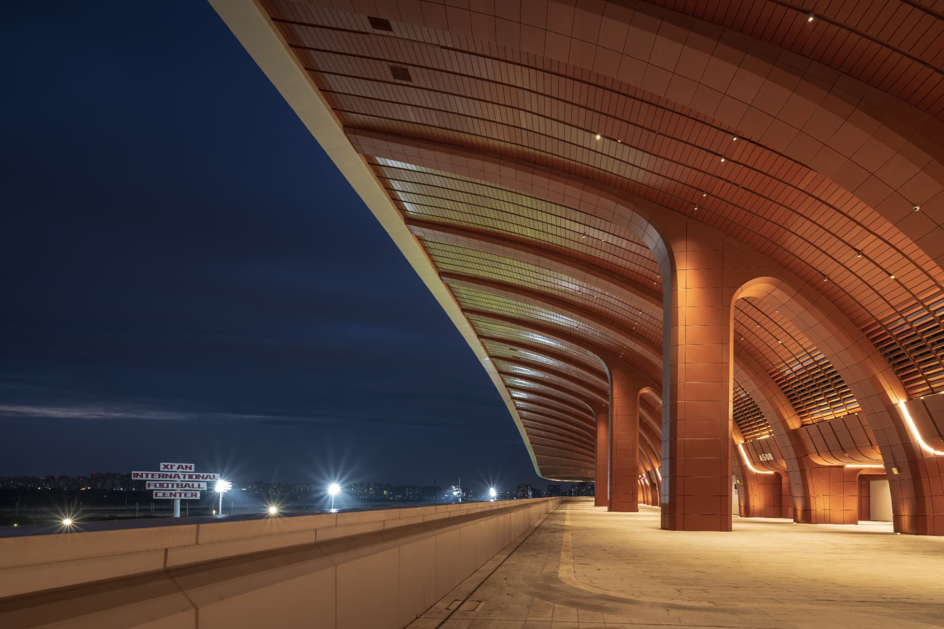 Xi'an International Football Stadium — Xi'an, China: Xi'an International Football Stadium, Xi'an — terracotta colonnade and illuminated ceiling of the outer walkway