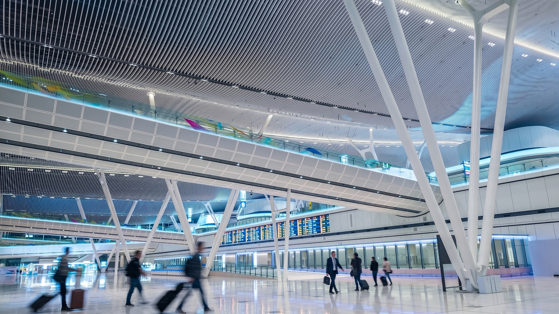 Hong Kong International Airport – Terminal 2 — Hong Kong: Hong Kong International Airport Terminal 2 — upper level walkway with linear ceiling light, Lichtvision lighting design